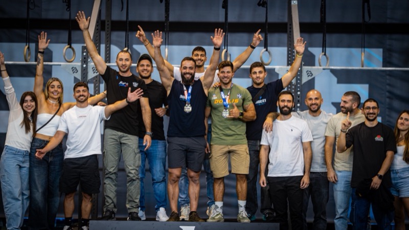 The CrossFit IRONSKY team on the podium at a competition.