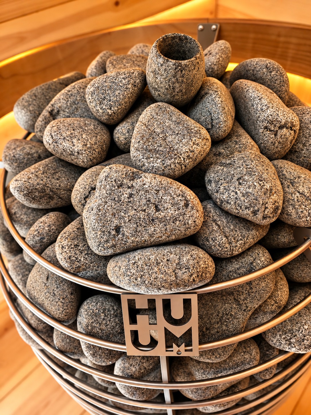 Close-up of the round grey stones stacked in the HUUM heater basket.